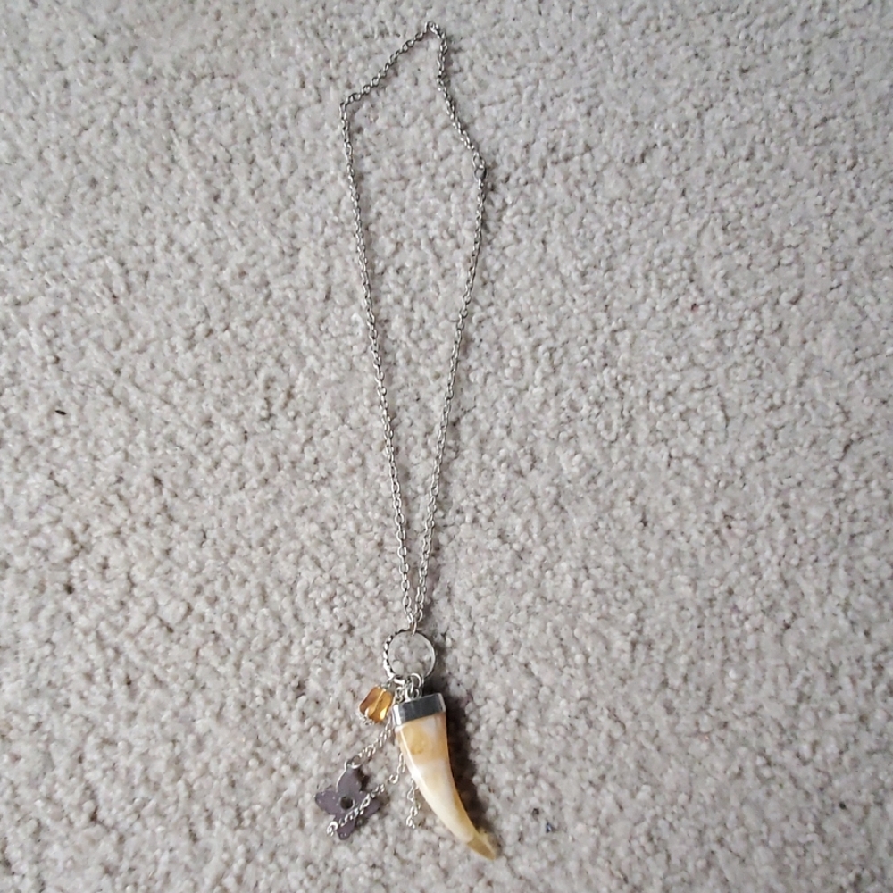 A silver and orange necklace